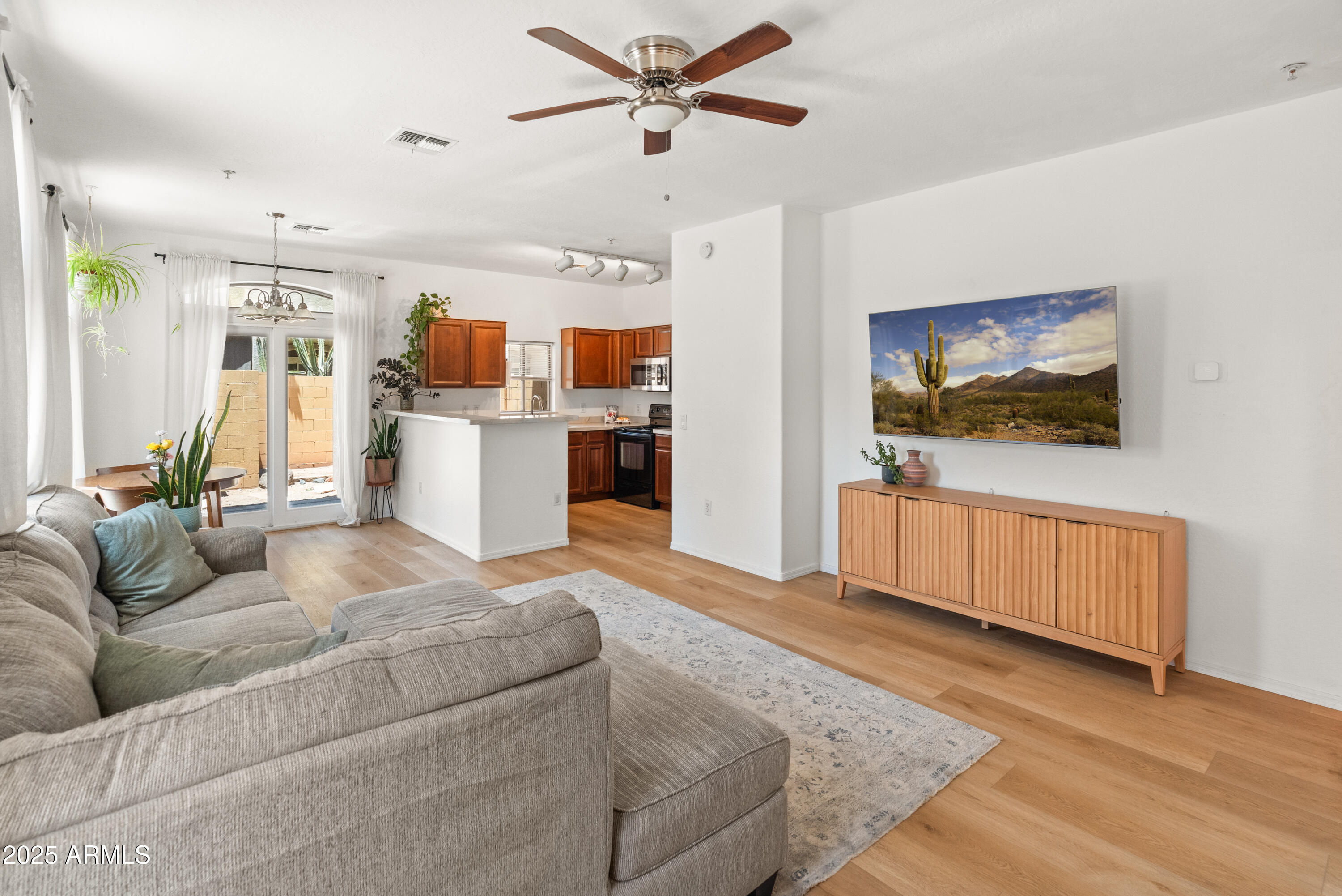 2150 East Bell Road, Unit 1088 Phoenix, AZ 85022 - Photo 8 of 25 a living room with furniture and kitchen view