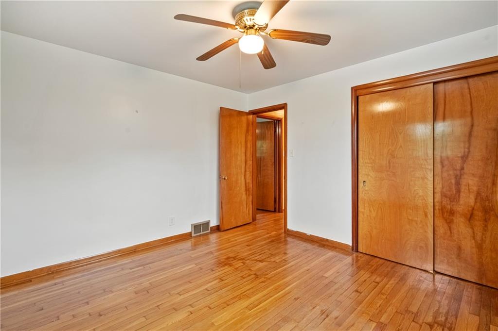124 Clover Drive Monaca, PA 15061 - Photo 15 of 27 an empty room with wooden floor closet and ceiling fan