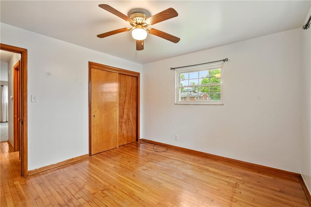 124 Clover Drive Monaca, PA 15061 - Photo 16 of 27 a view of an empty room with wooden floor and a window
