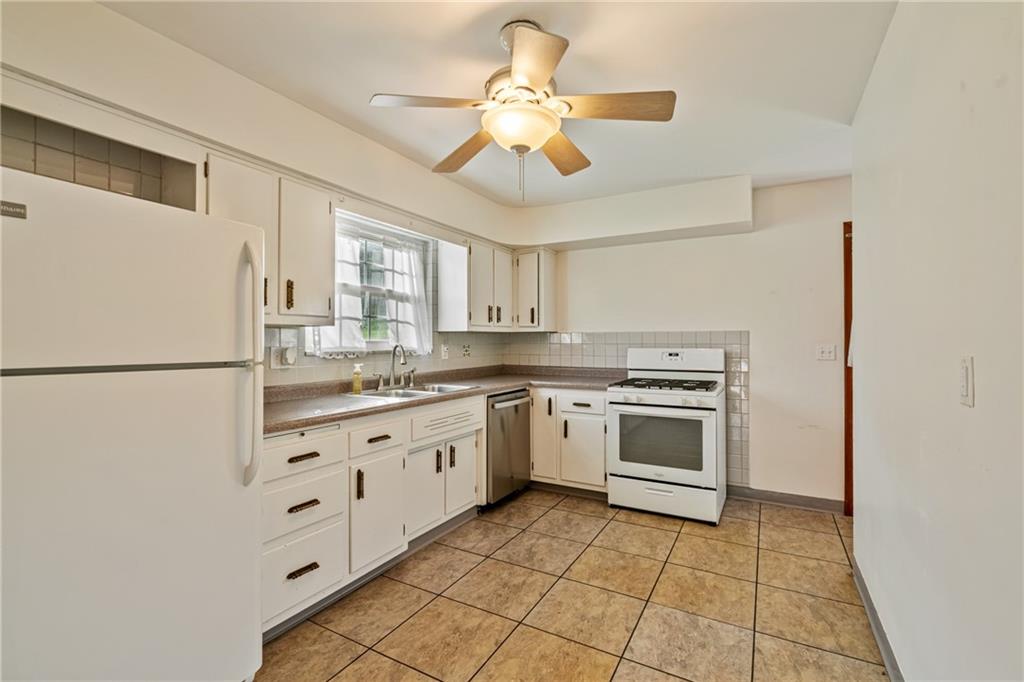 124 Clover Drive Monaca, PA 15061 - Photo 9 of 27 a kitchen with granite countertop cabinets and white appliances