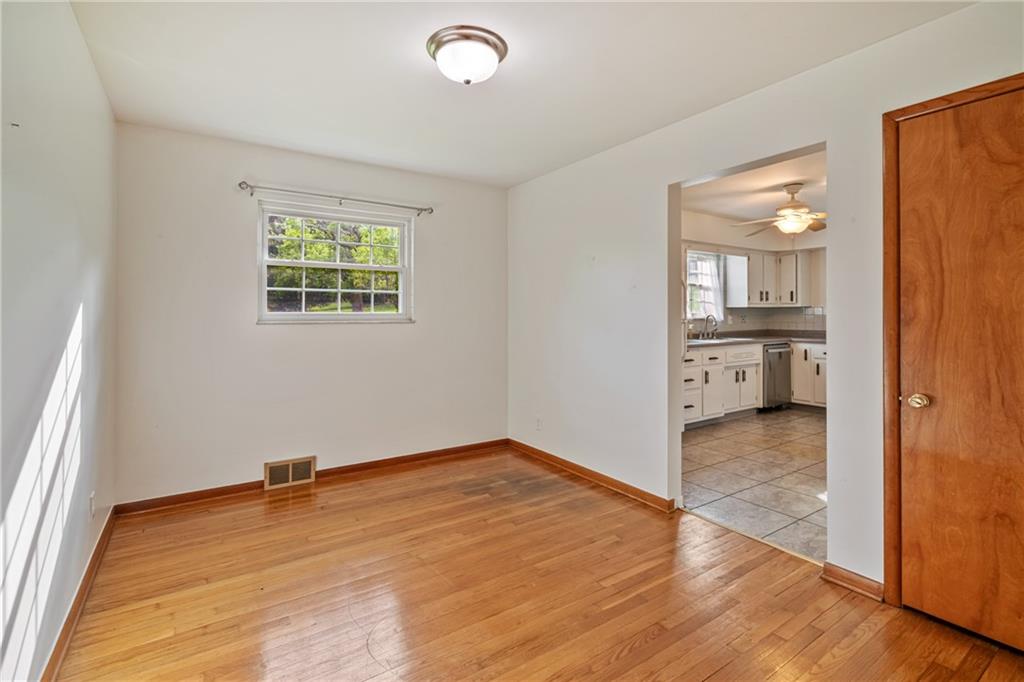 124 Clover Drive Monaca, PA 15061 - Photo 10 of 27 an empty room with wooden floor and a window