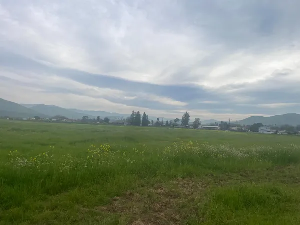 a view of a field with an outdoor space