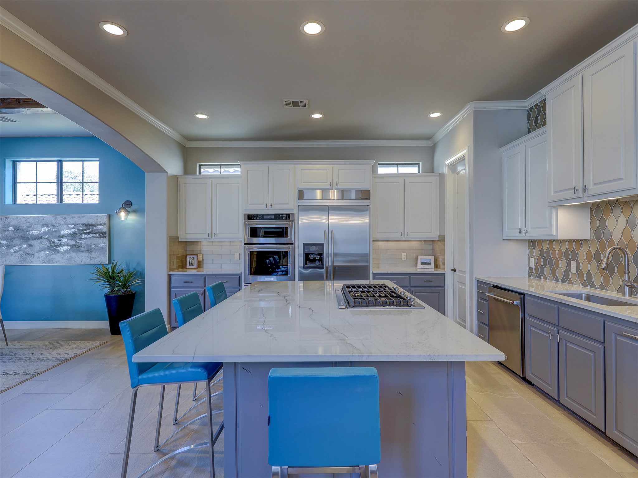 11805 Pleasant Panorama View Austin, TX 78738 - Photo 15 of 40 A culinary enthusiast’s dream, this gourmet kitchen features a sprawling quartz island and high end stainless steel appliances.