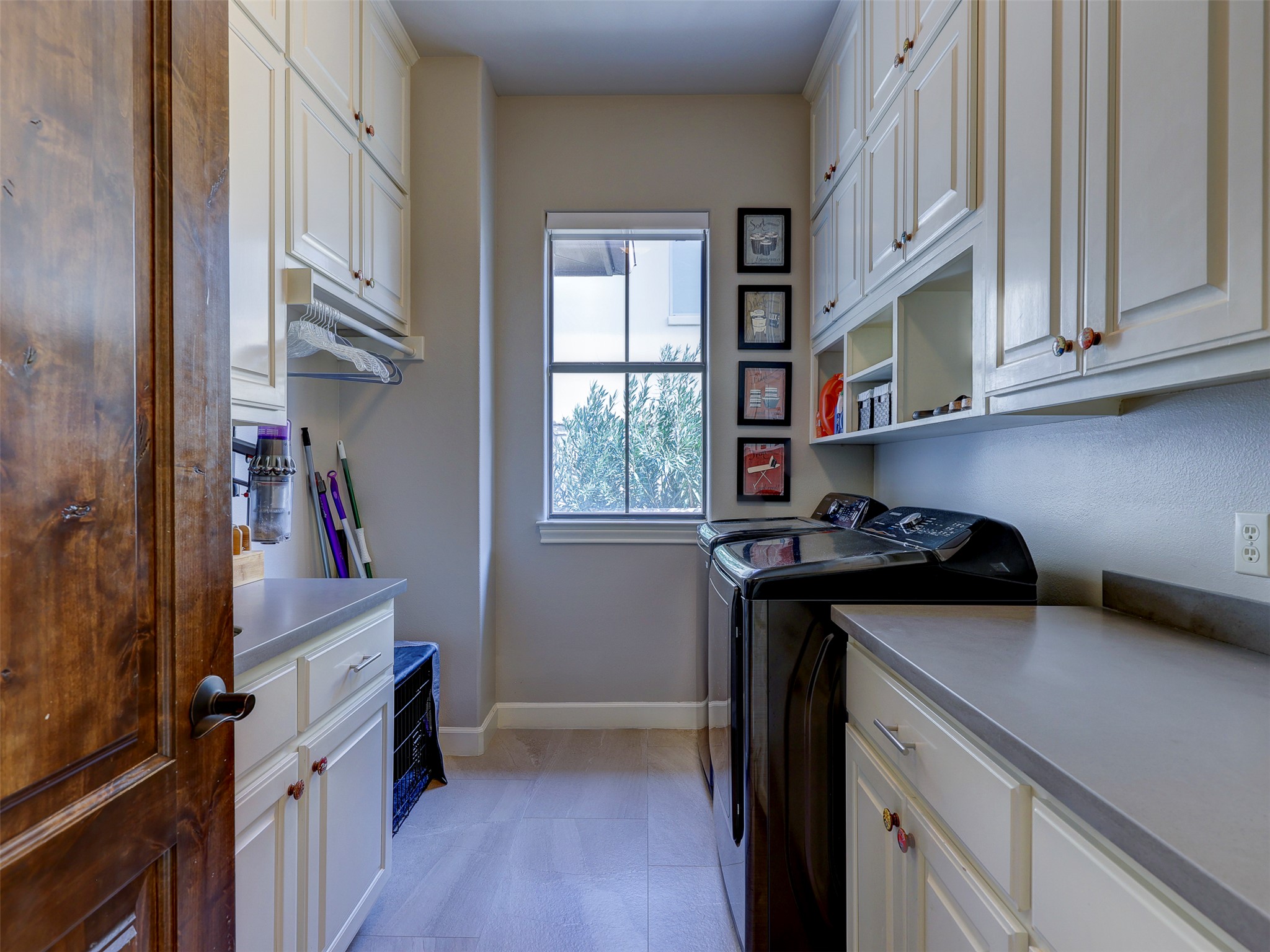 11805 Pleasant Panorama View Austin, TX 78738 - Photo 17 of 40 The oversized laundry room offers plenty of space and storage.