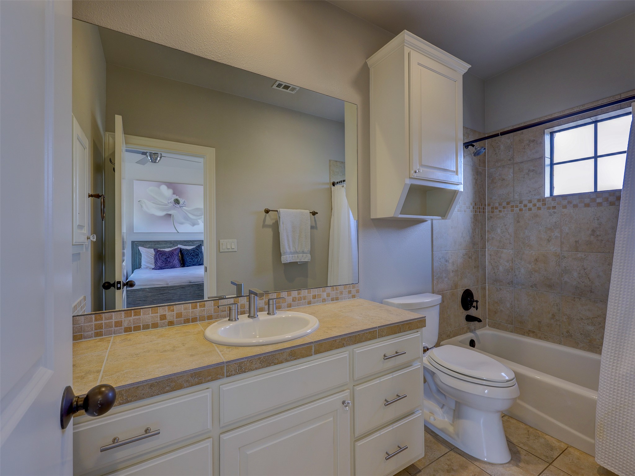 11805 Pleasant Panorama View Austin, TX 78738 - Photo 31 of 40 Plenty of cabinet space here and natural light make this bathroom warm and inviting.
