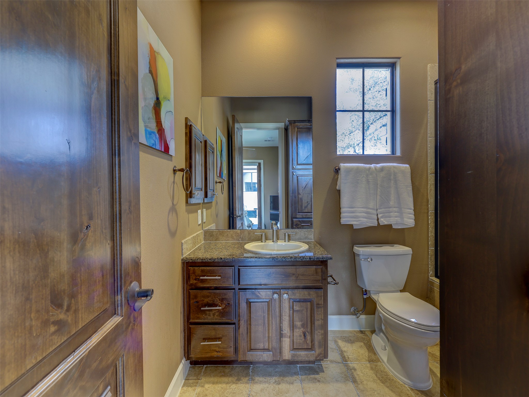 11805 Pleasant Panorama View Austin, TX 78738 - Photo 34 of 40 Plenty of cabinets ensure ample storage and the window allows natural light without compromising privacy.