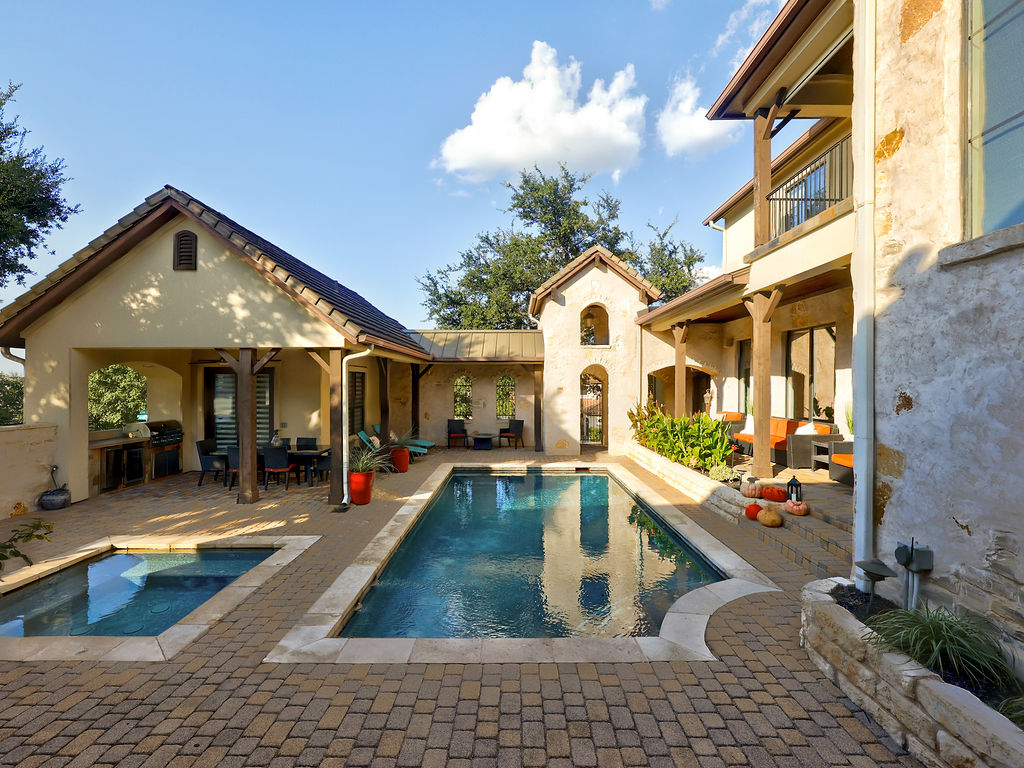 11805 Pleasant Panorama View Austin, TX 78738 - Photo 35 of 40 Step into a private sanctuary where the lines between indoor and outdoor living disappear. The centerpiece of this estate is a shimmering resort-style pool and separate spa, framed by a sprawling hand-laid paver courtyard.