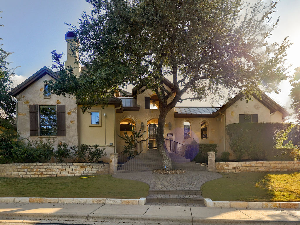 11805 Pleasant Panorama View Austin, TX 78738 - Photo 4 of 40 The sprawling exterior is defined by sophisticated stone masonry and elegant, multi-tiered rooflines that create a timeless silhouette.