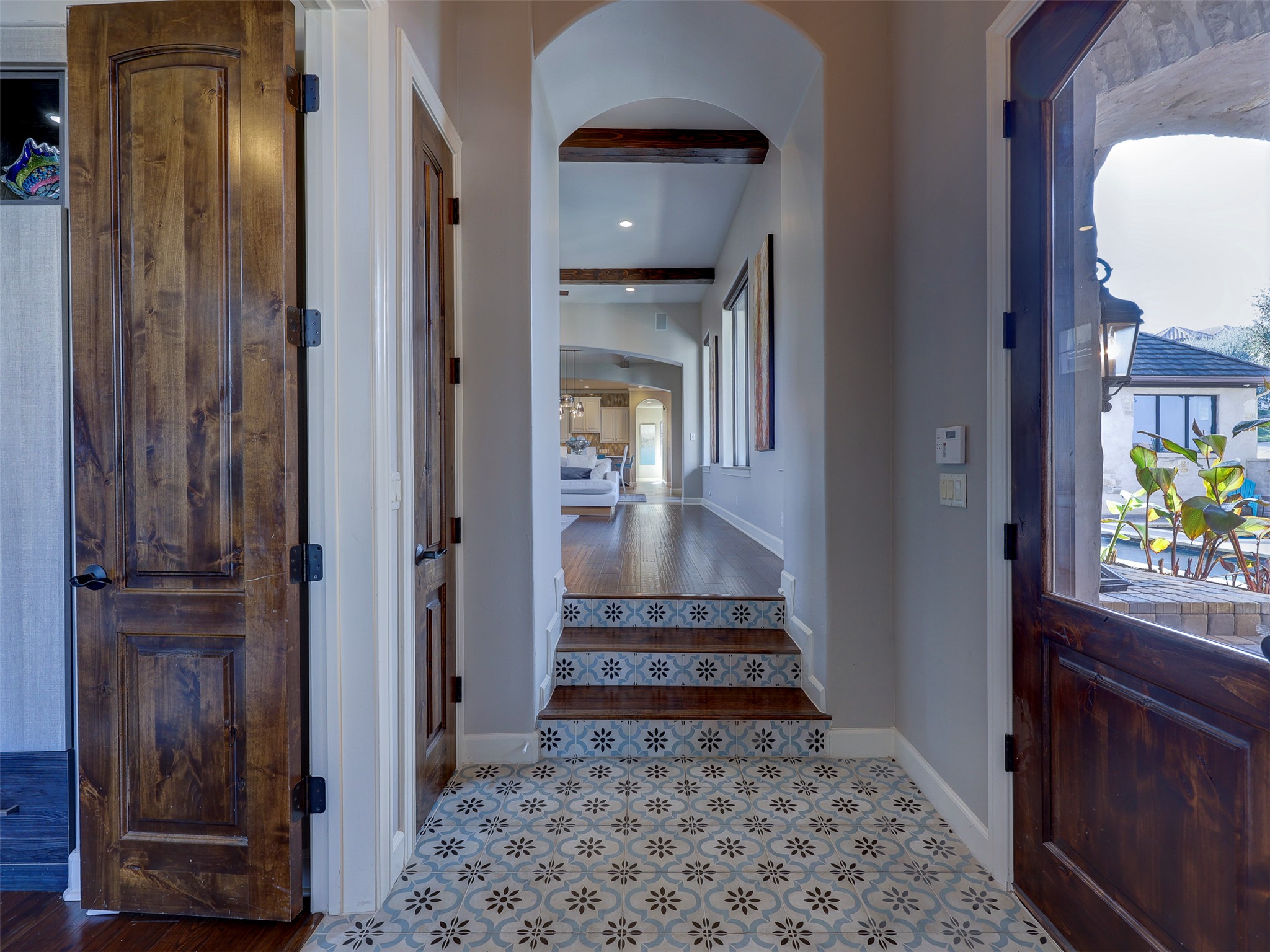 11805 Pleasant Panorama View Austin, TX 78738 - Photo 7 of 40 The arched entryway serves as a bridge between the private wings and the homes social heart.