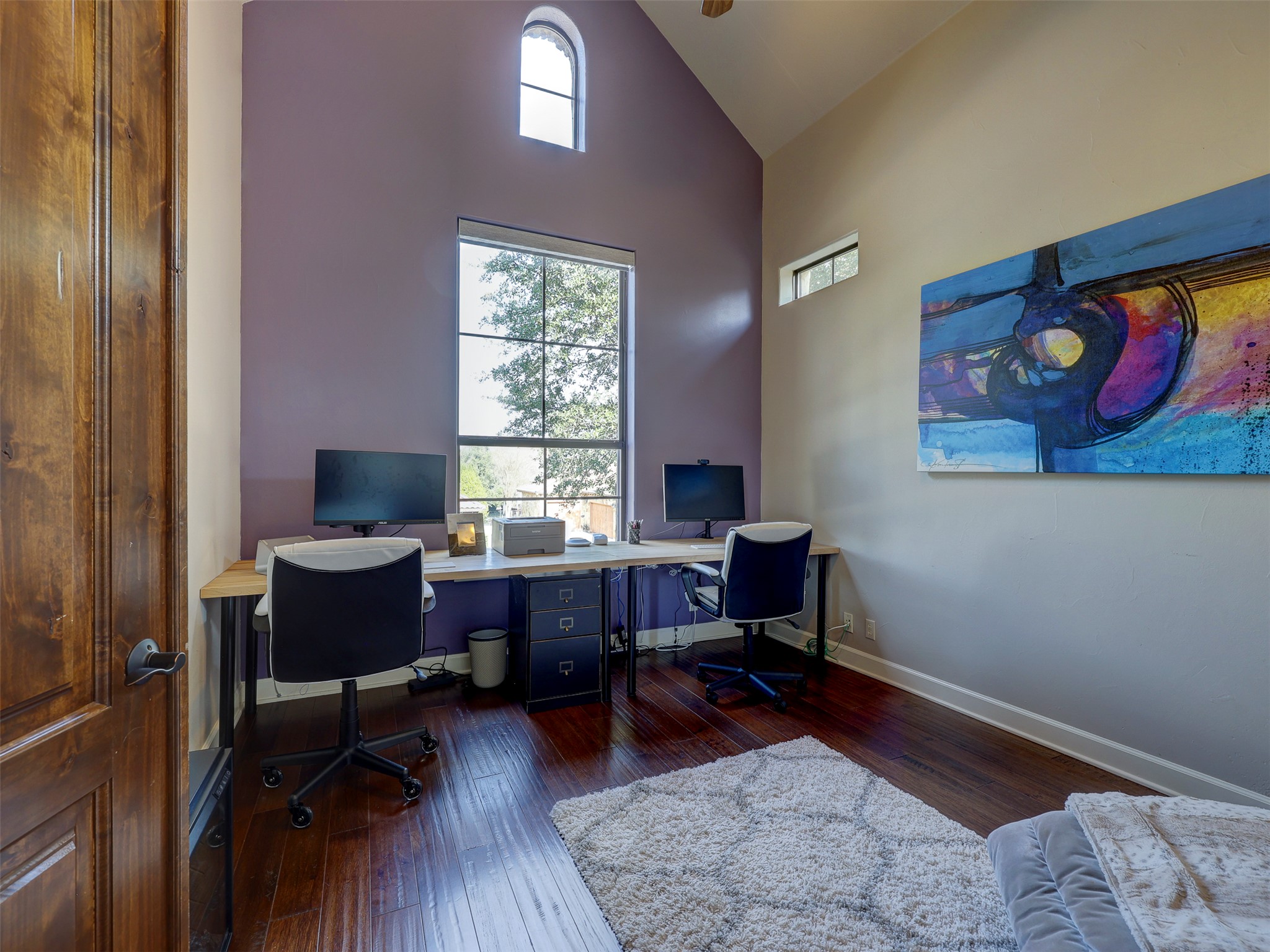 11805 Pleasant Panorama View Austin, TX 78738 - Photo 8 of 40 This light filled home office features vaulted ceilings and a dramatic accent wall creating an environment of focus and inspiration.