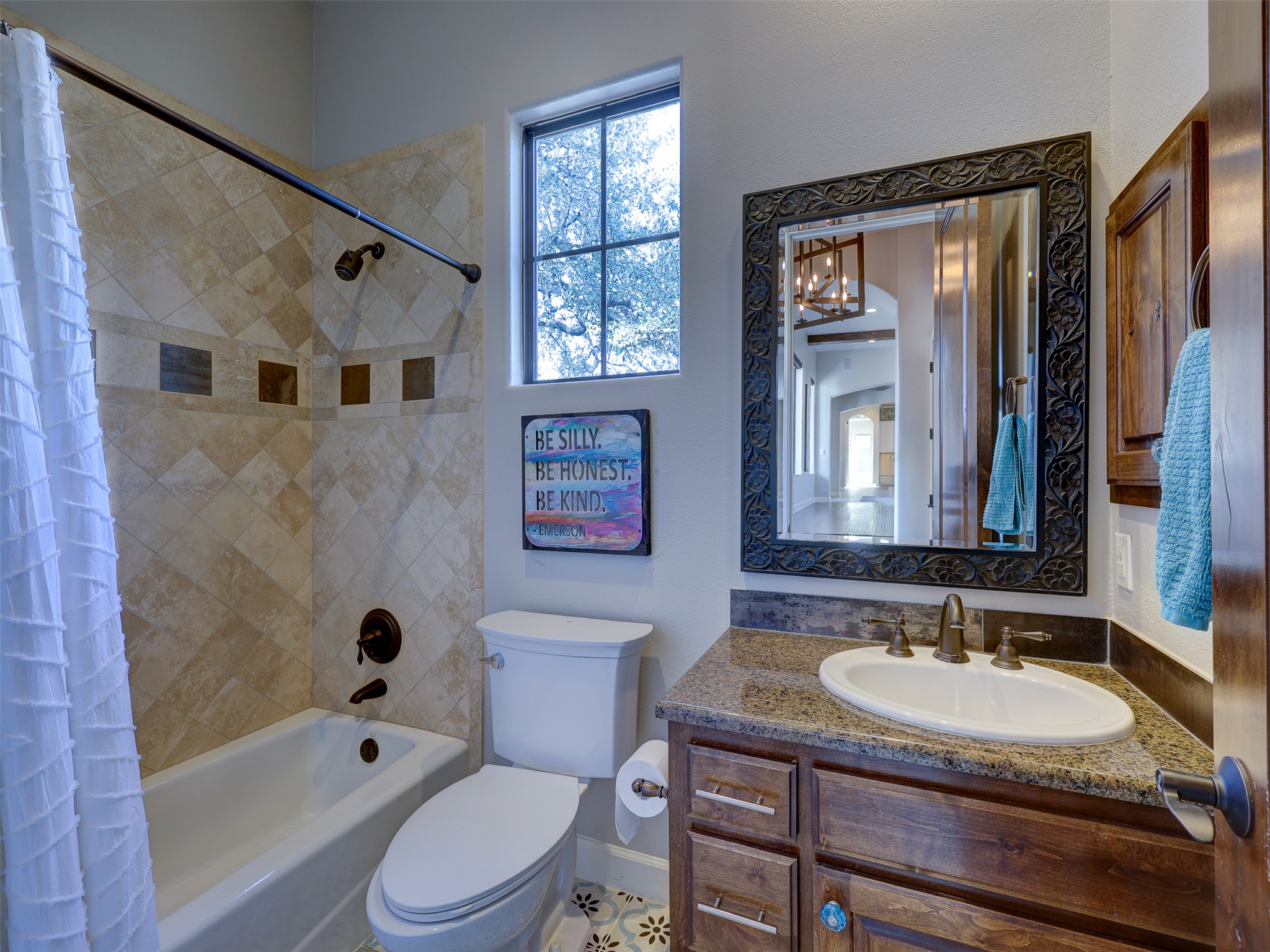 11805 Pleasant Panorama View Austin, TX 78738 - Photo 9 of 40 No detail has been overlooked in this elegant bathroom, featuring a custom wood mirror frame that serves as a focal point.