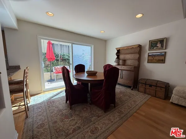 a dining room with furniture a rug and wooden floor