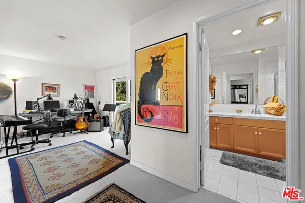 a living room with furniture and paintings on the wall