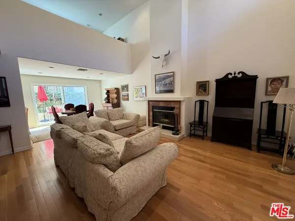 a living room with furniture flat screen tv and a fireplace