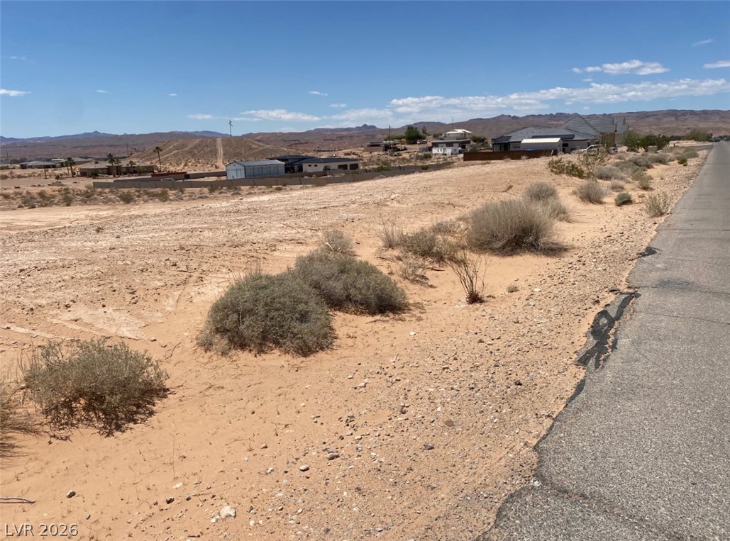 3175 Lou Street Logandale, NV 89021 - Photo 2 of 4 This expansive desert lot offers unparalleled opportunities for custom development amidst rugged natural beauty.