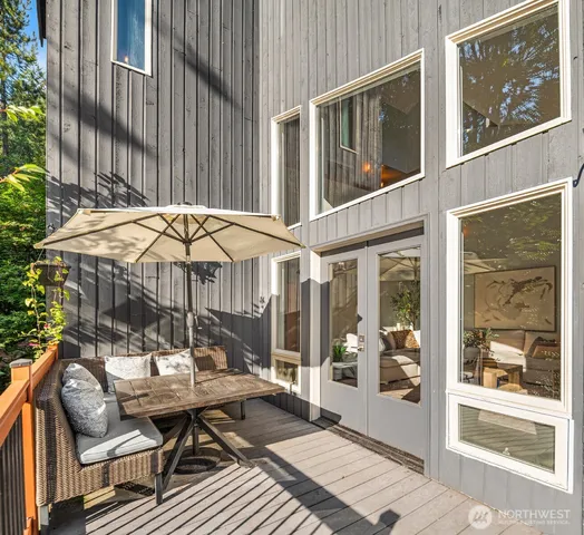 a backyard of a house with barbeque oven table and chairs