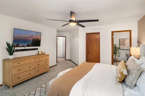 a bedroom with a bed and a flat screen tv