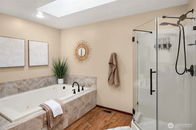 a bathroom with a tub and a shower