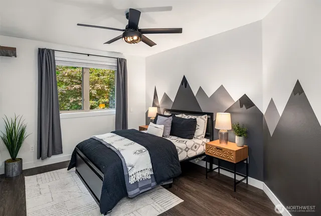 a bedroom with a bed and wooden floor