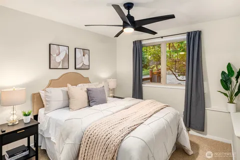 a bedroom with a large bed and a window