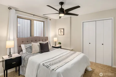 a bedroom with a large bed and a chandelier