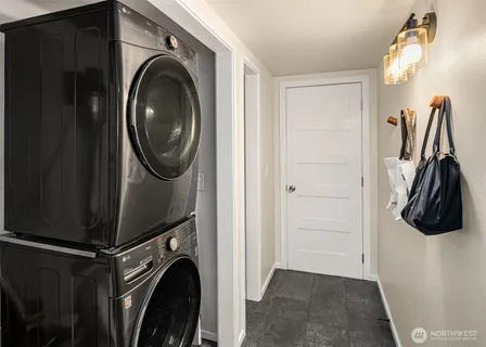a close view of a utility room with dryer and washer