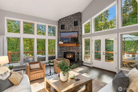 a living room with furniture a large window and a fireplace
