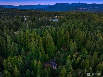 a view of a lush green hillside and a building in the background