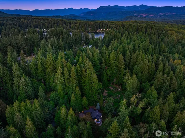 a view of a lush green hillside and a building in the background