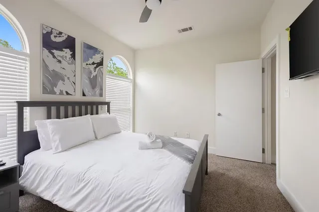 a bedroom with a bed and a flat screen tv