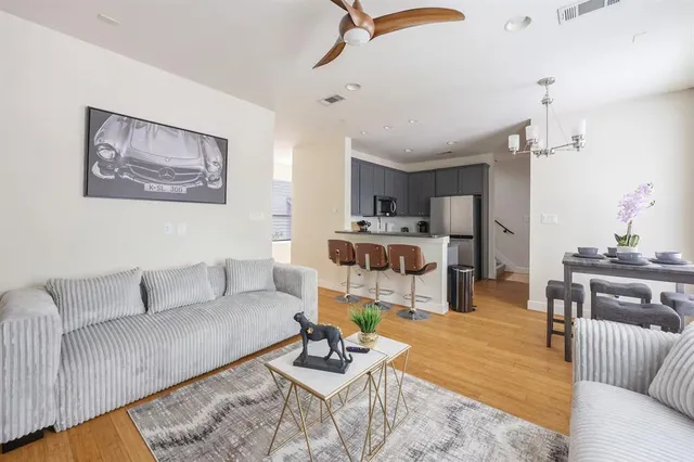 a living room with furniture and view of kitchen