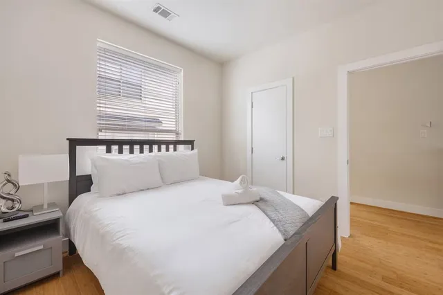 a bedroom with a bed and a window