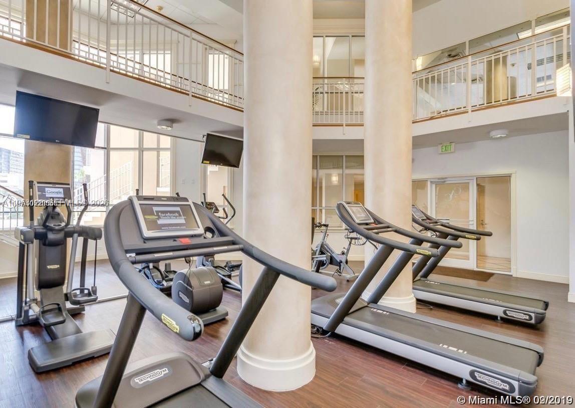701 Brickell Key Boulevard, Unit 2004 Miami, FL 33131 - Photo 15 of 17 a view of a room with gym equipment