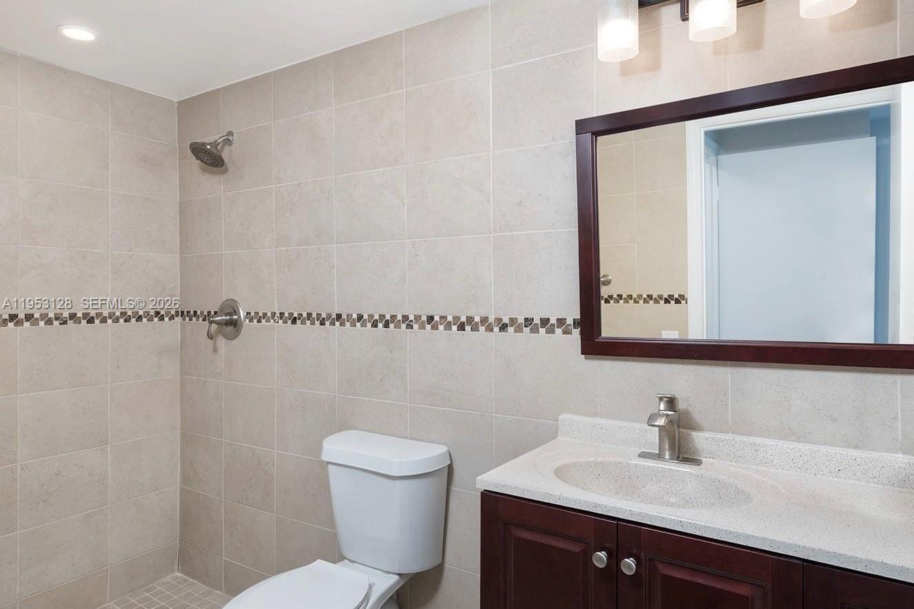701 Brickell Key Boulevard, Unit 2004 Miami, FL 33131 - Photo 7 of 17 a bathroom with a sink mirror vanity and toilet