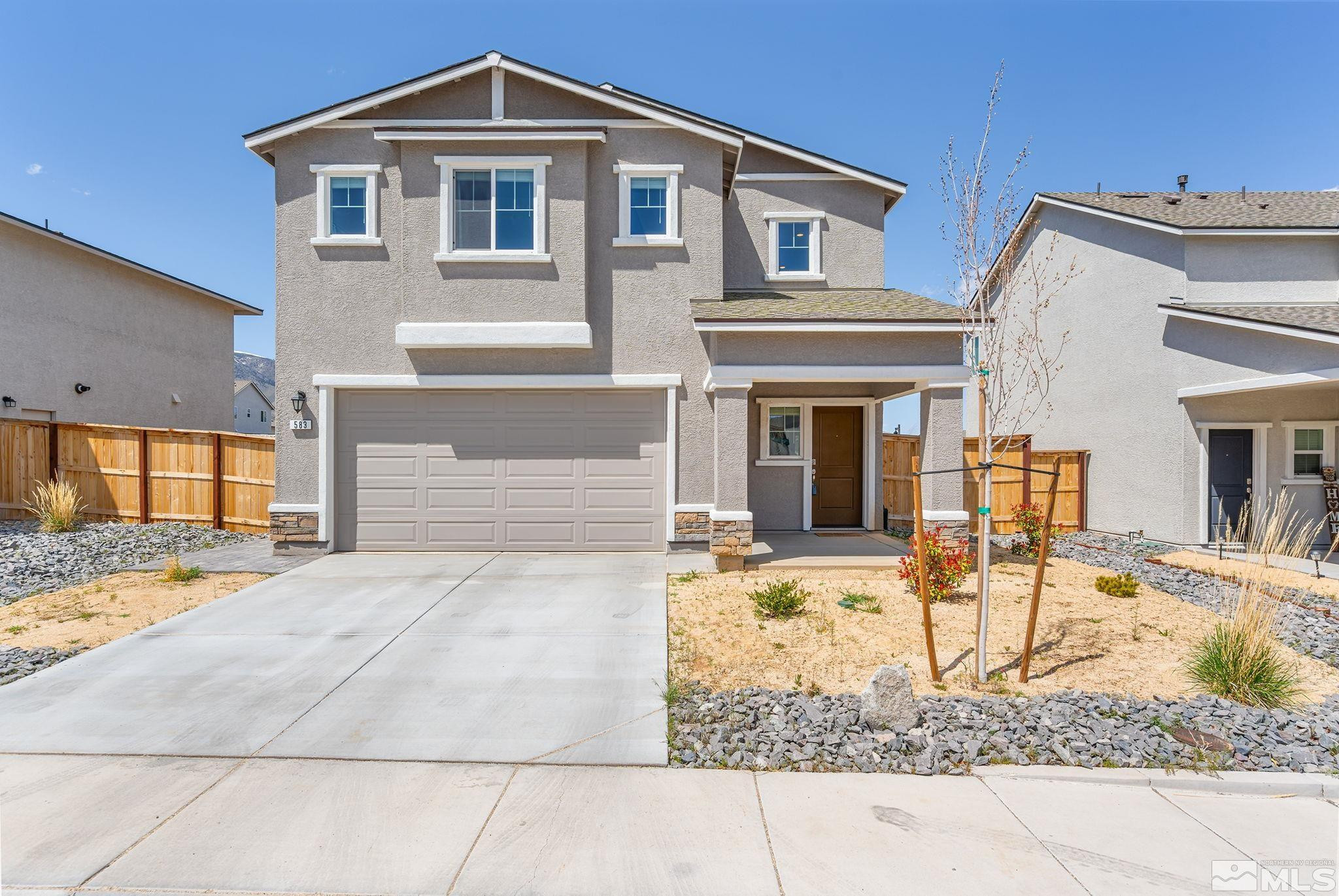 a front view of a house with basket ball court