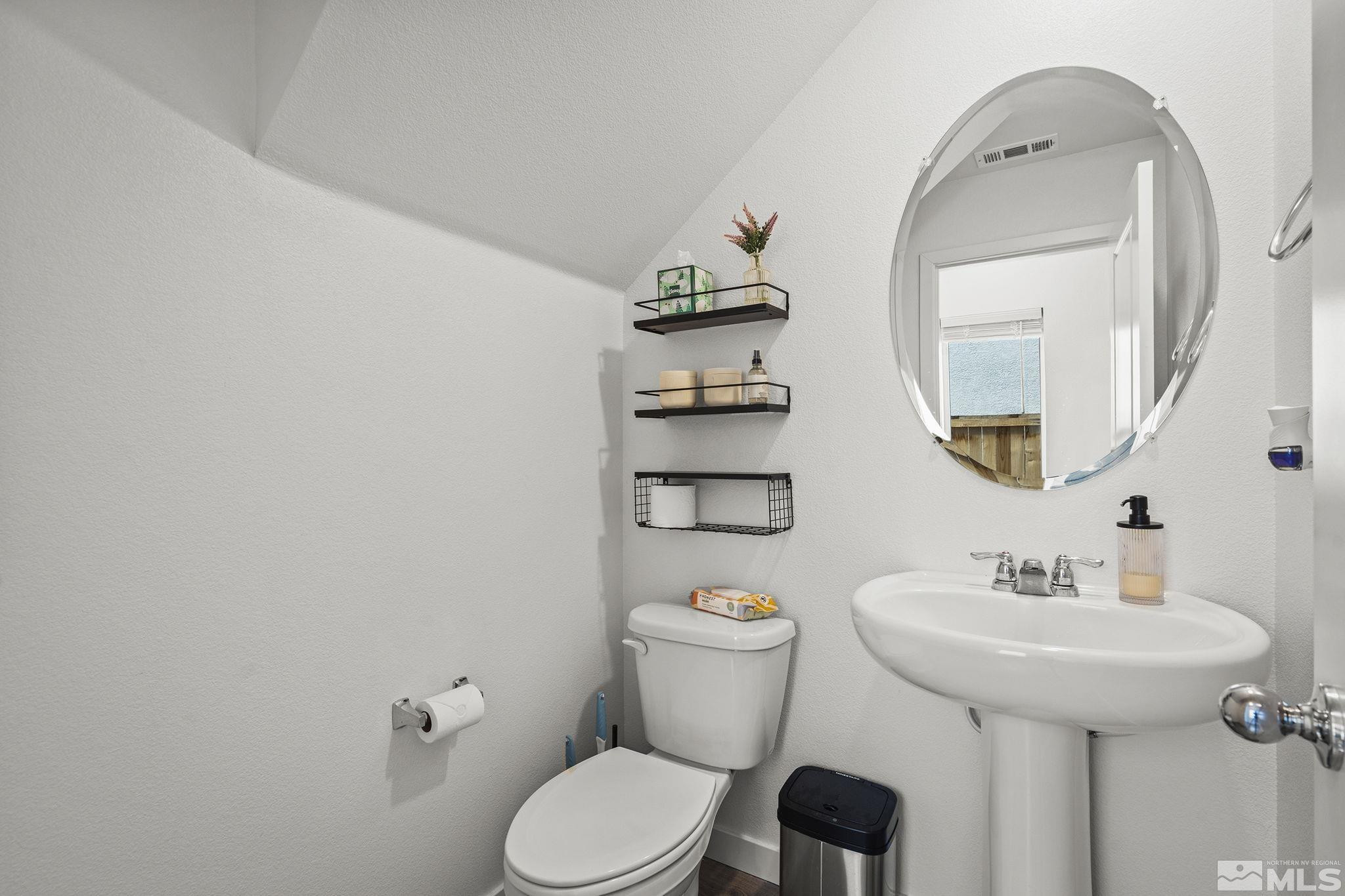 583 Iris Rainbow Drive Reno, NV 89506 - Photo 11 of 22 a bathroom with a toilet sink and mirror