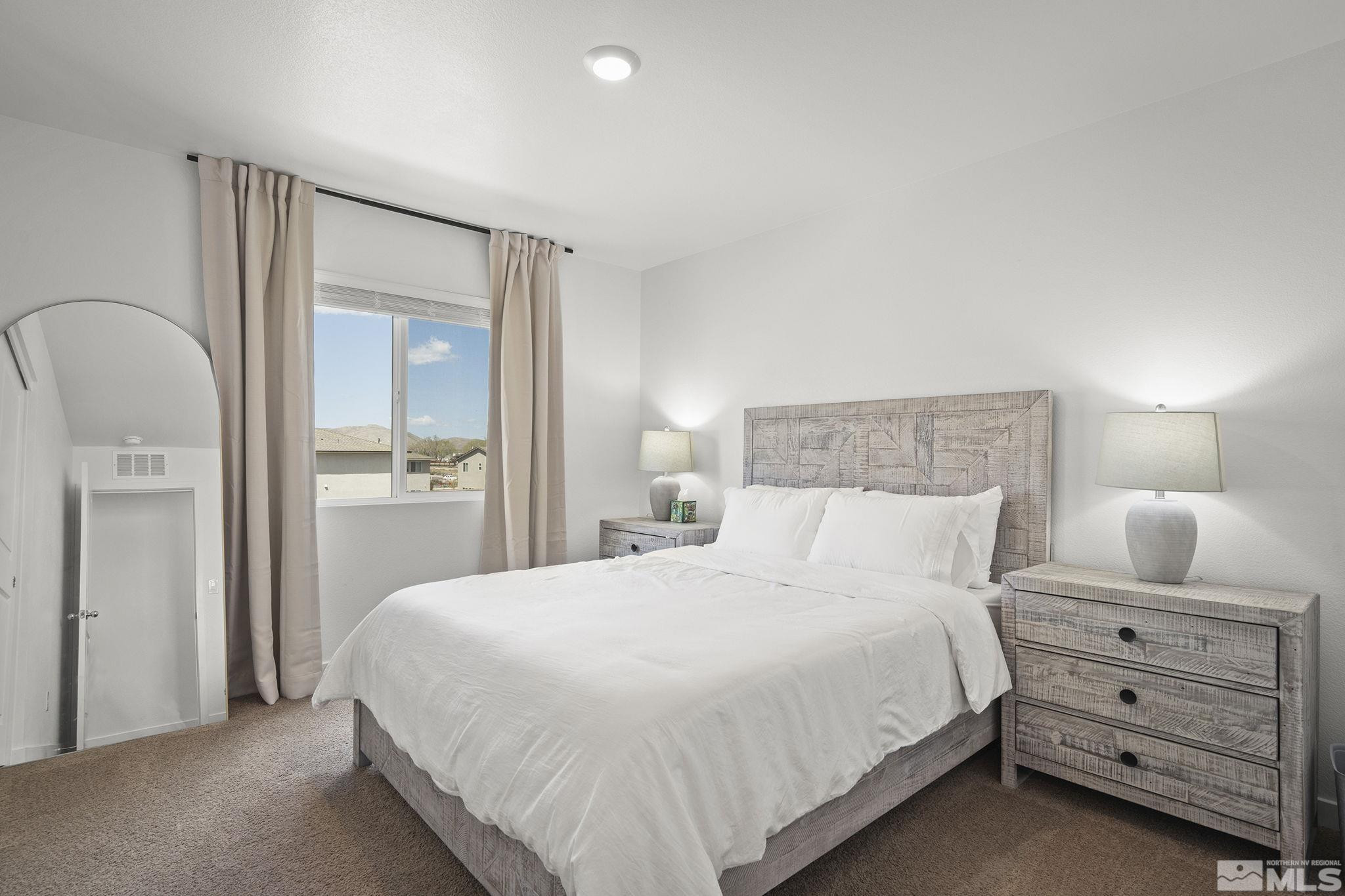 583 Iris Rainbow Drive Reno, NV 89506 - Photo 13 of 22 a bedroom with a bed and lamp