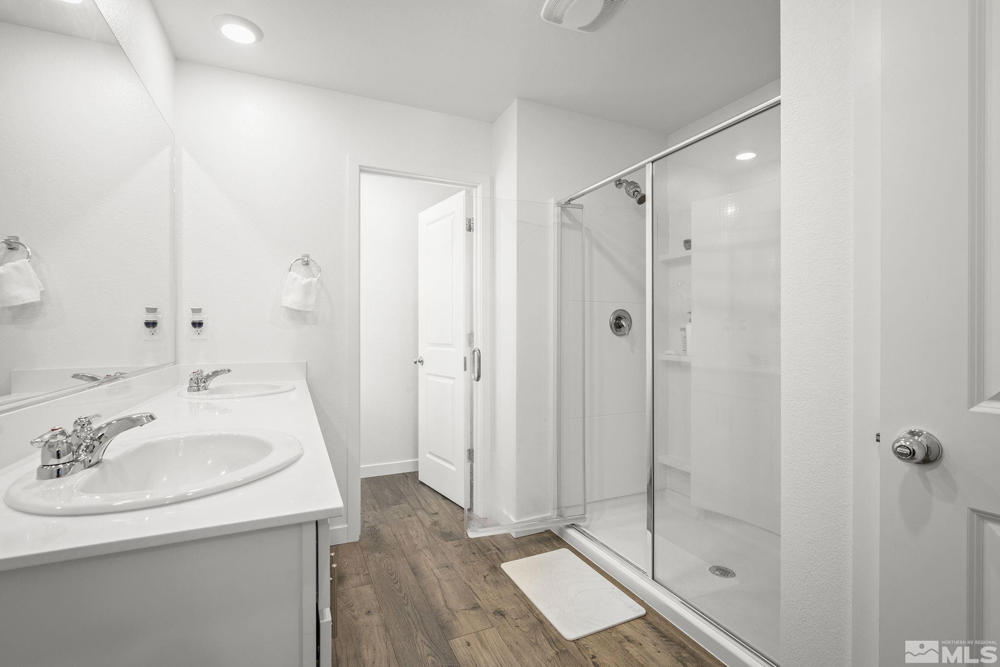 583 Iris Rainbow Drive Reno, NV 89506 - Photo 14 of 22 a bathroom with a sink shower and a mirror