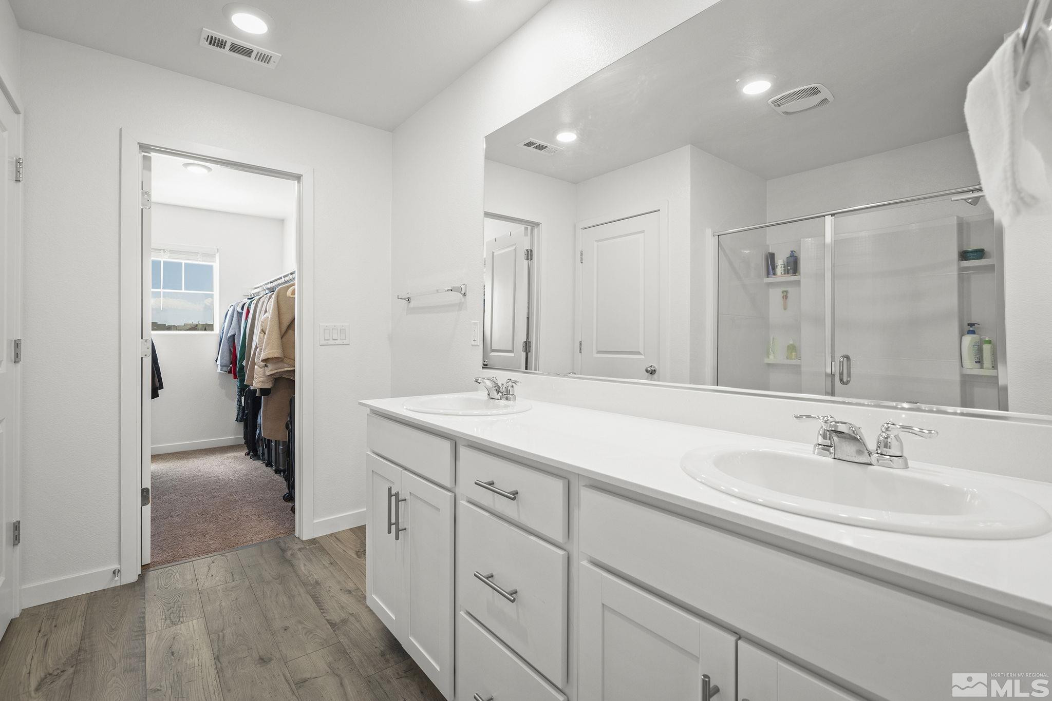 583 Iris Rainbow Drive Reno, NV 89506 - Photo 15 of 22 a bathroom with a sink double vanity and shower