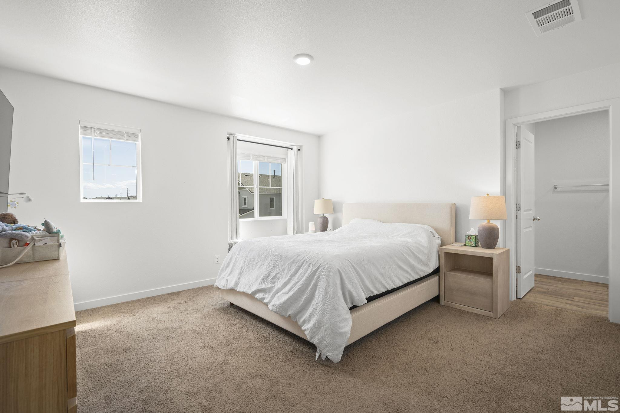 583 Iris Rainbow Drive Reno, NV 89506 - Photo 16 of 22 a bedroom with a bed and a night stand