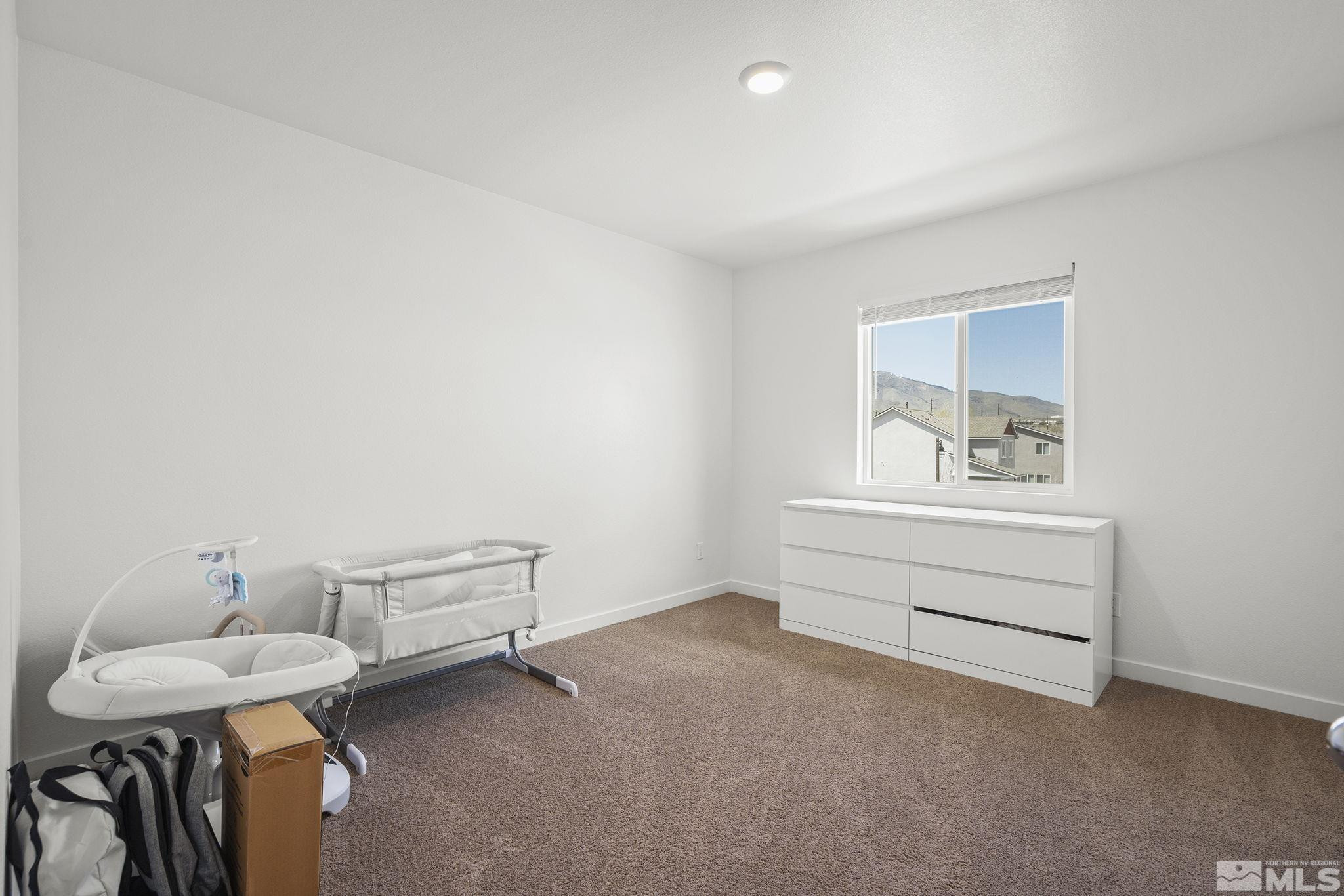 583 Iris Rainbow Drive Reno, NV 89506 - Photo 17 of 22 a room with furniture and window