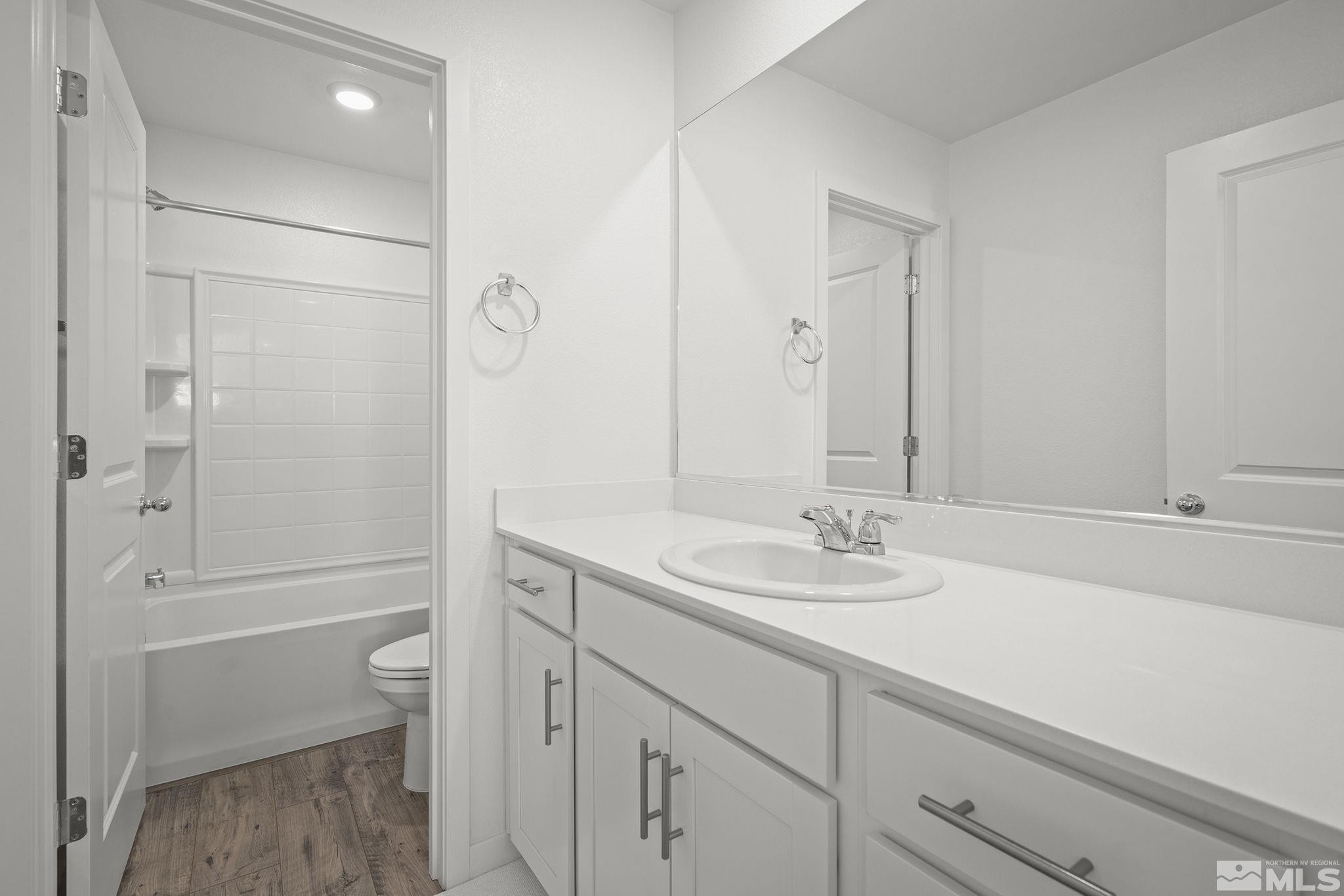 583 Iris Rainbow Drive Reno, NV 89506 - Photo 18 of 22 a bathroom with a sink a toilet and shower