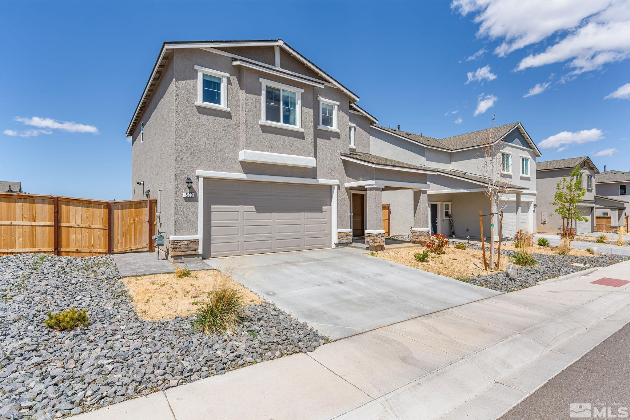 583 Iris Rainbow Drive Reno, NV 89506 - Photo 2 of 22 a front view of a house with garden