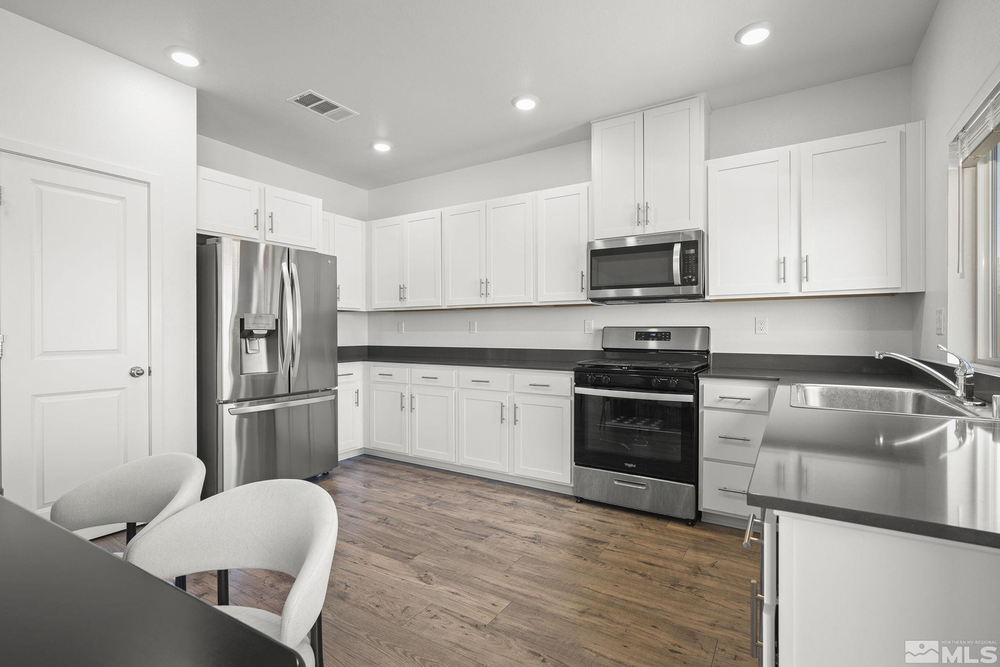 583 Iris Rainbow Drive Reno, NV 89506 - Photo 10 of 22 a kitchen with a refrigerator stove and microwave