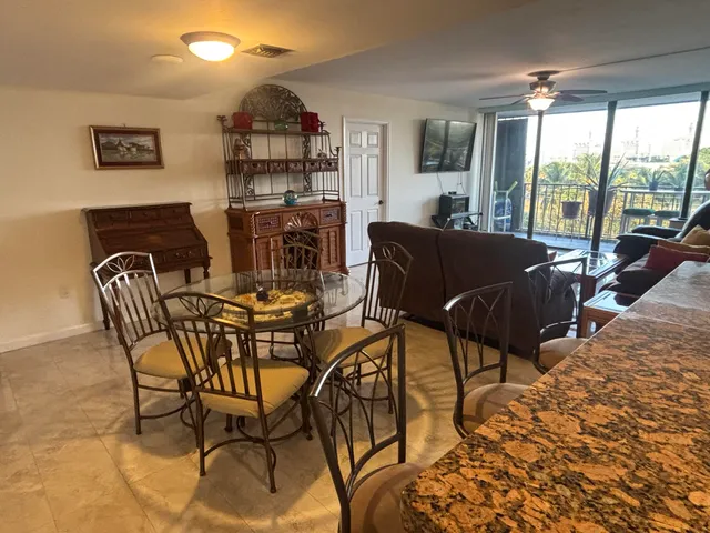 a dining area with chandelier and outdoor view