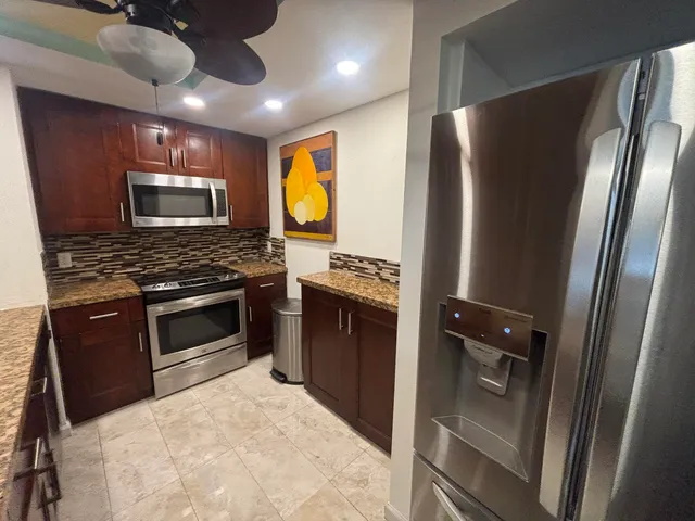 a bedroom with a bed a dresser and a window