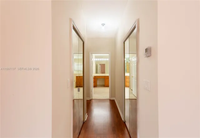 a view of a hallway with wooden floor