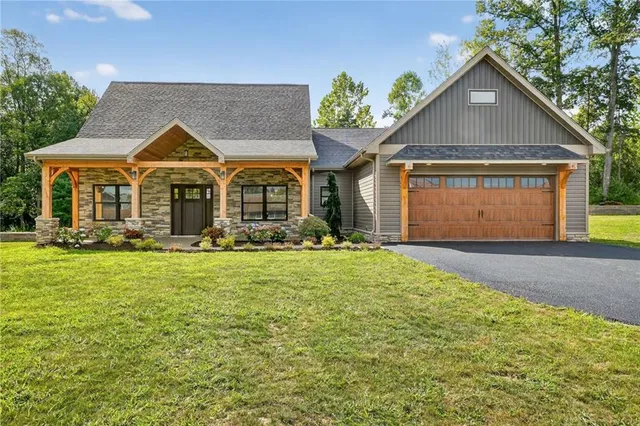 a front view of a house with a garden and plants