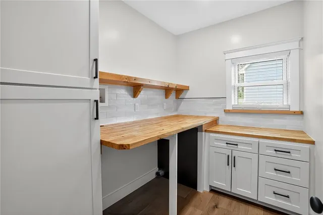 a utility room with granite countertop cabinets washer and dryer