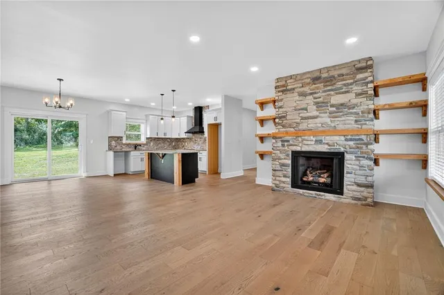 a view of a kitchen with a fireplace and a window